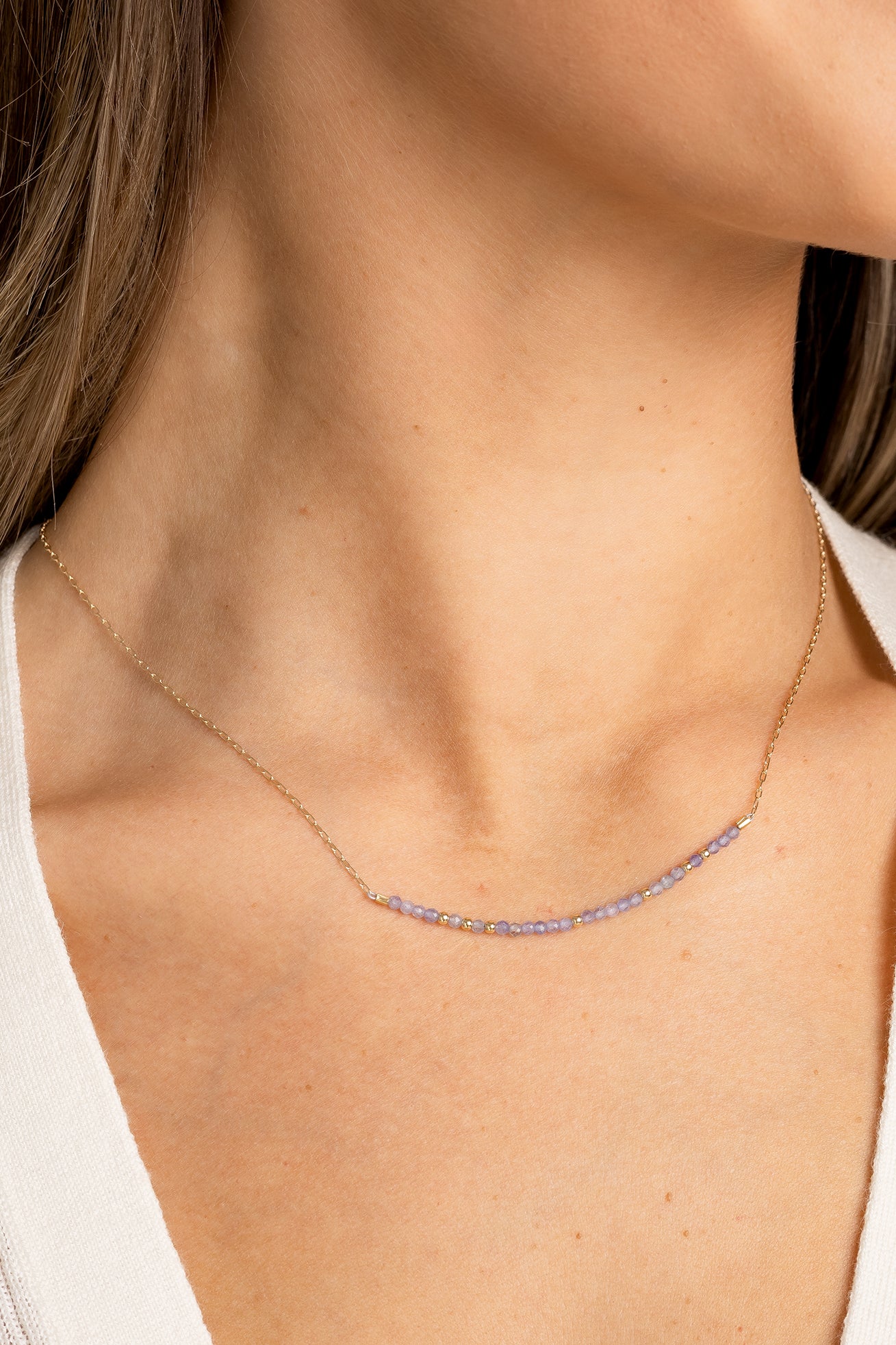 December birthstone bar necklace with tanzanite beads on a gold filled chain.