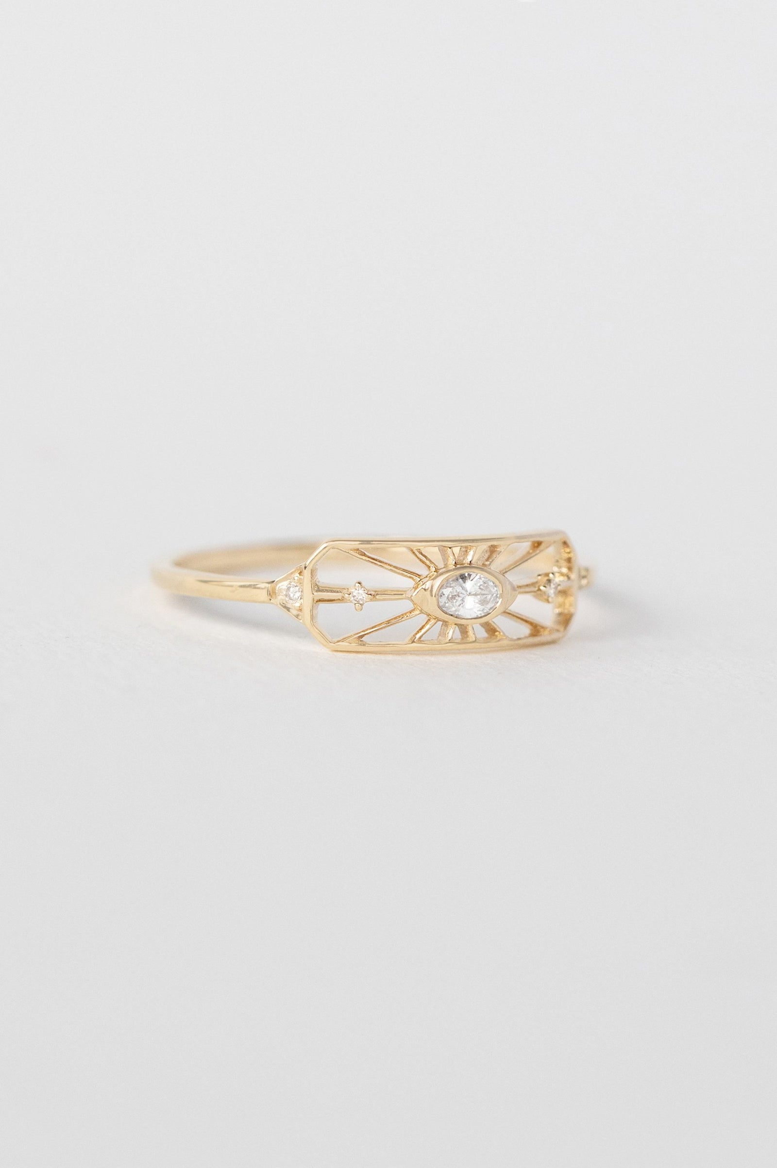 Dream maker open eye ring in 14k light yellow gold with an oval diamond by Celine Daoust.