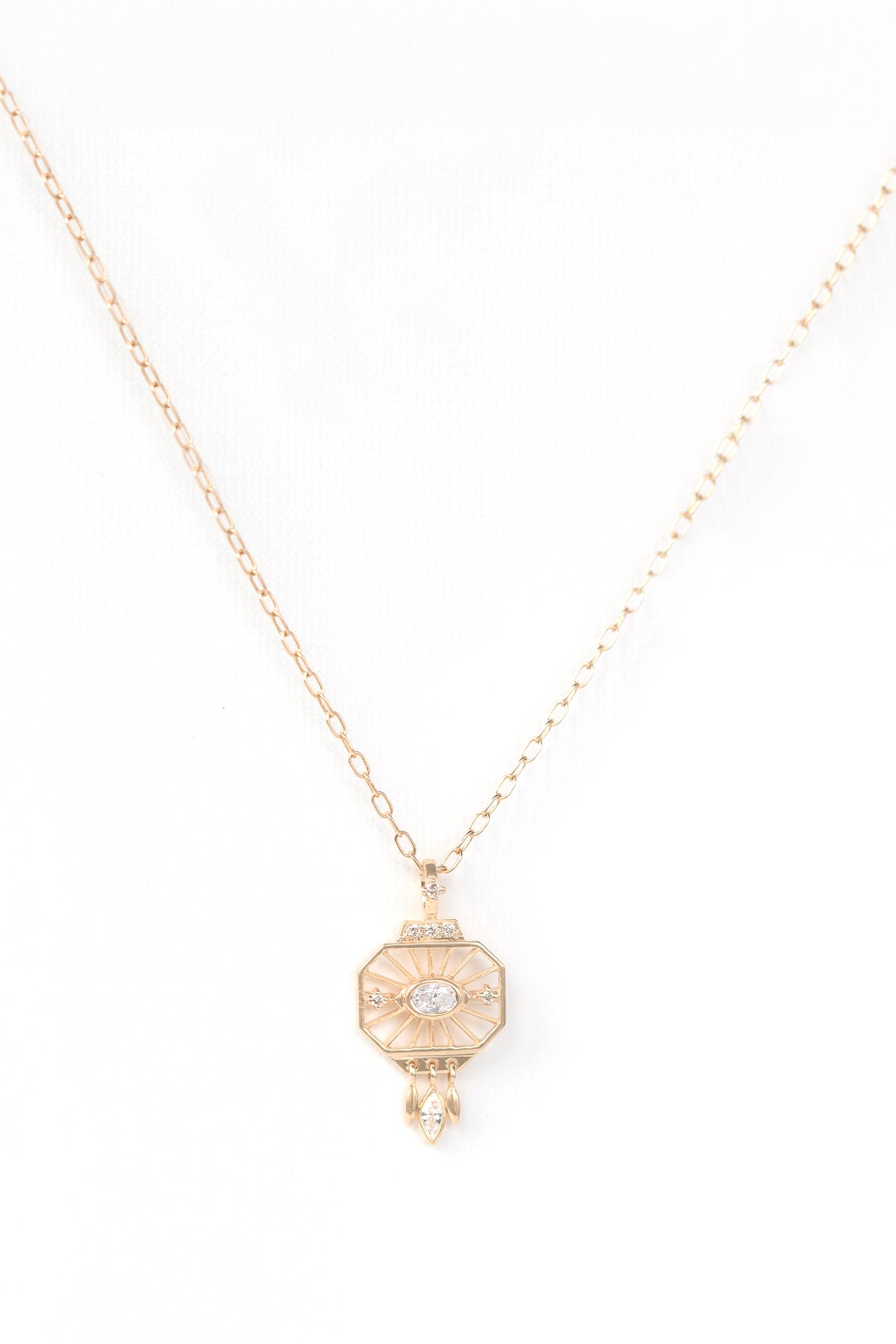 Dream maker open-eye octagonal pendant necklace in 14k gold set with oval and marquise diamonds.