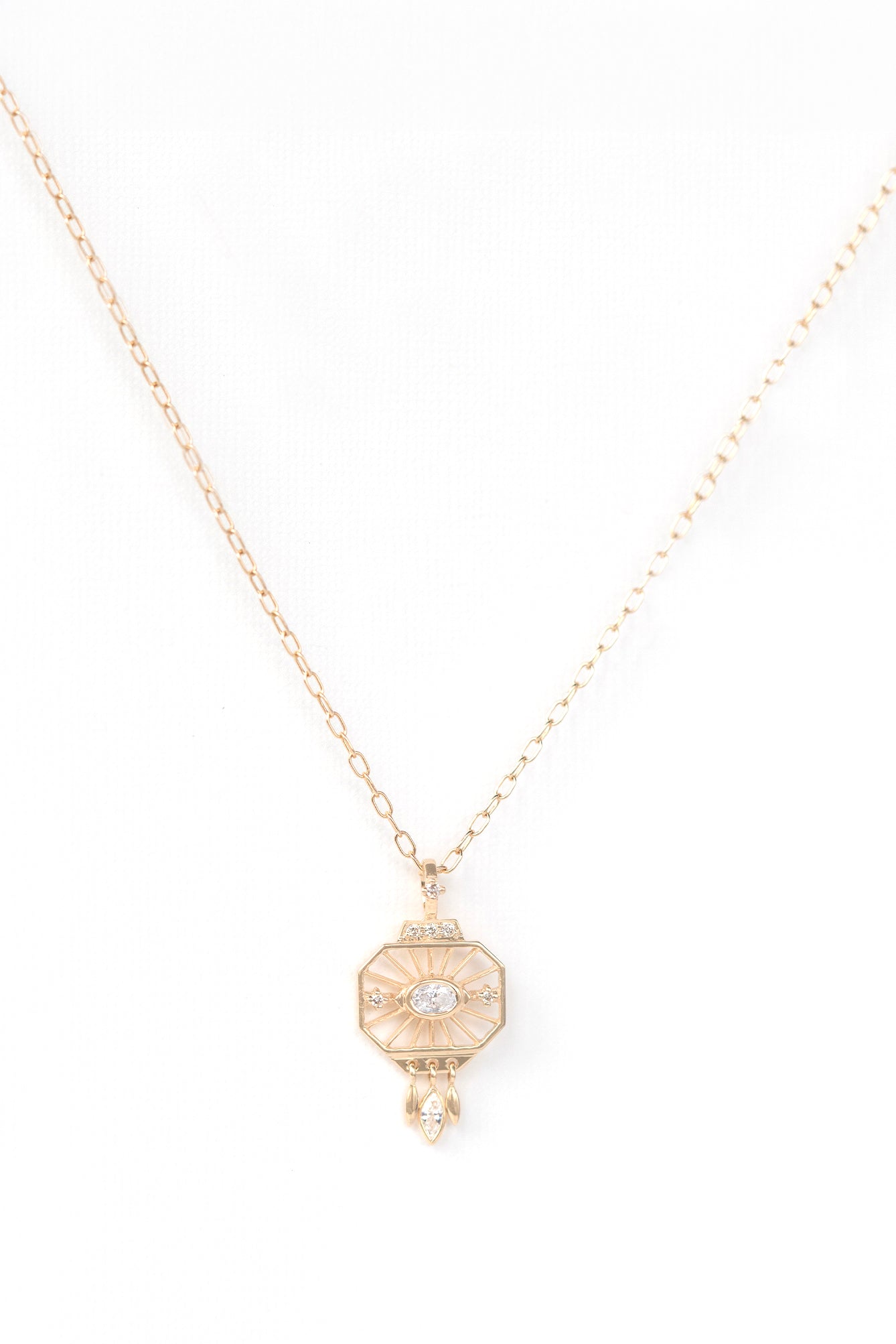 Woman wearing a dream maker open-eye diamond pendant necklace in 14k gold by Celine Daoust.
