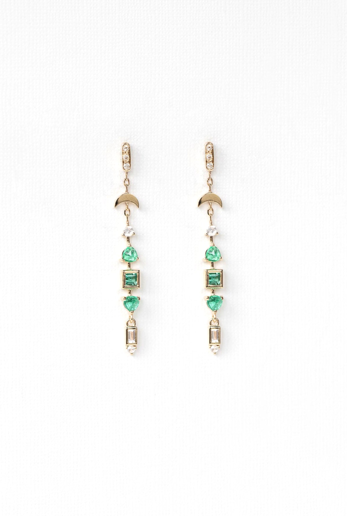 Close-up of emerald and diamond totem earring in 14k gold.