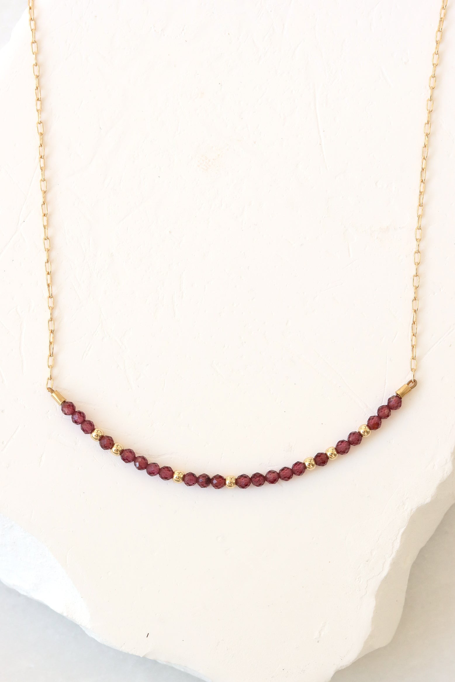 January birthstone bar necklace with garnet beads on a gold filled chain.