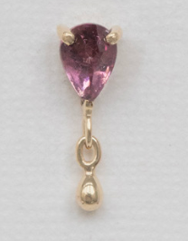 Close-up of the pear pink tourmaline and dangling gold detail on the flatback earring by Celine Daoust