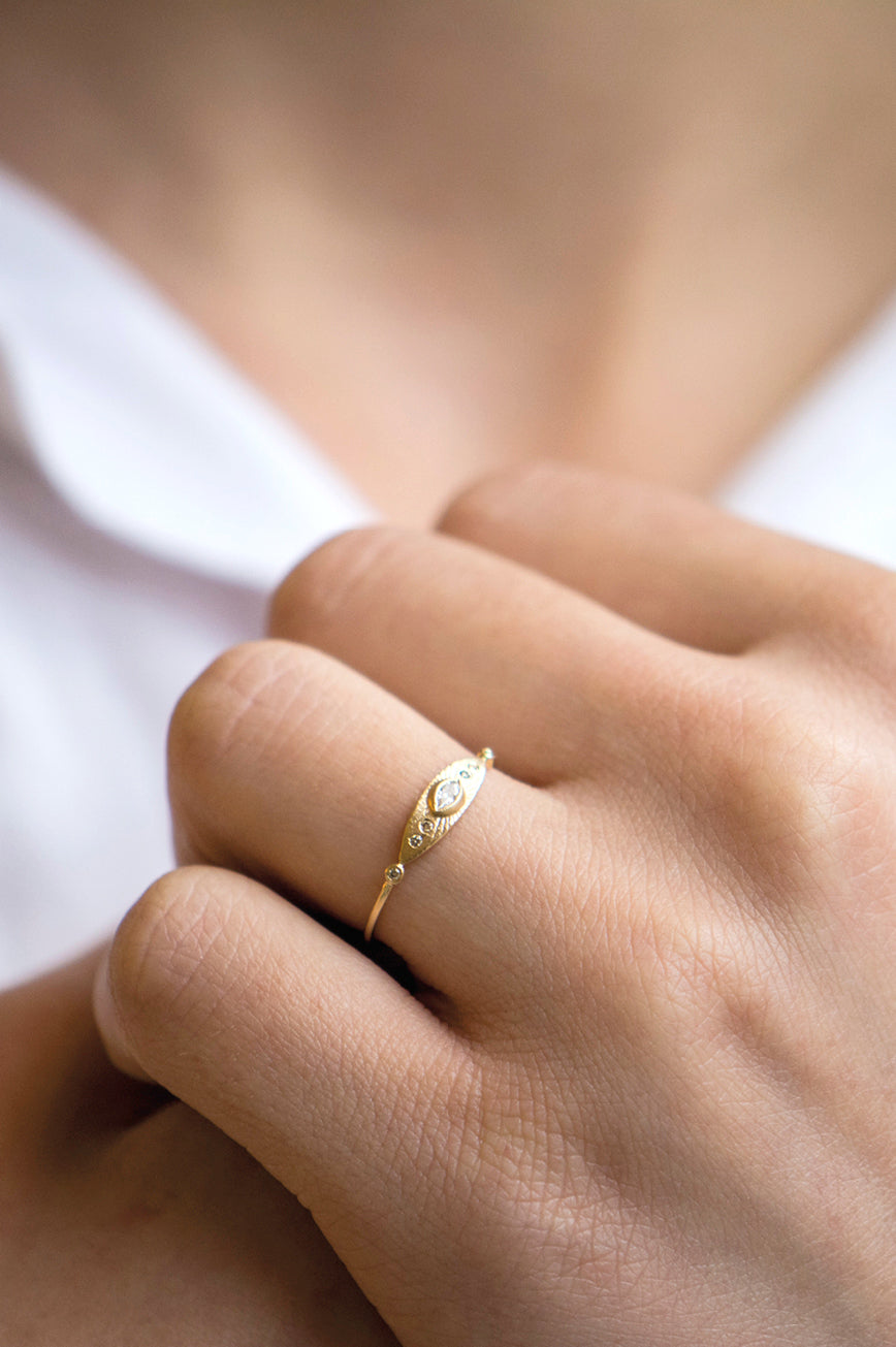 Sun eye ring in 14k yellow gold with a marquise diamond and six accent diamonds by Celine Daoust.