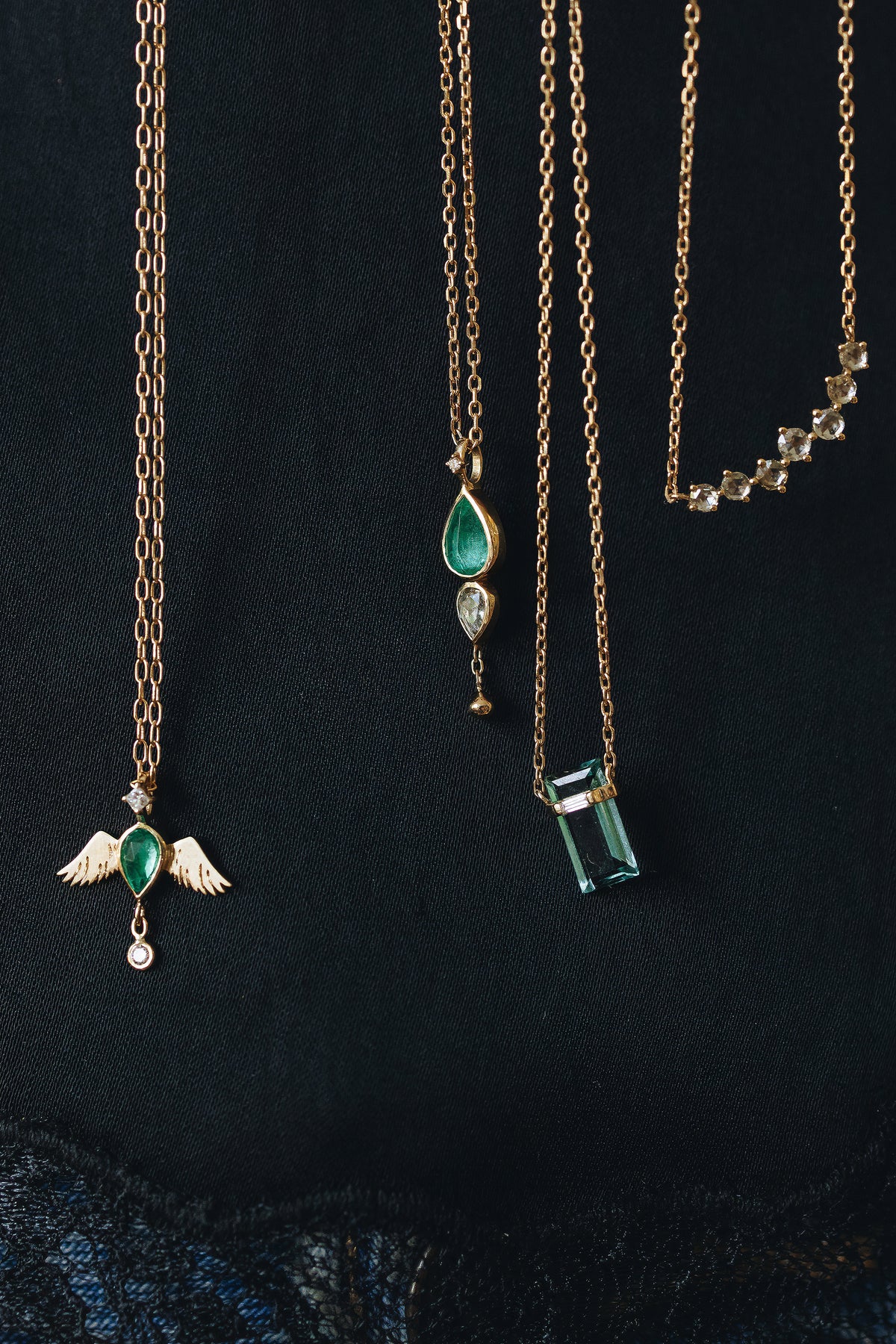 Celine Daoust pear emerald and diamonds angel chain necklace shown with other pieces from the collection