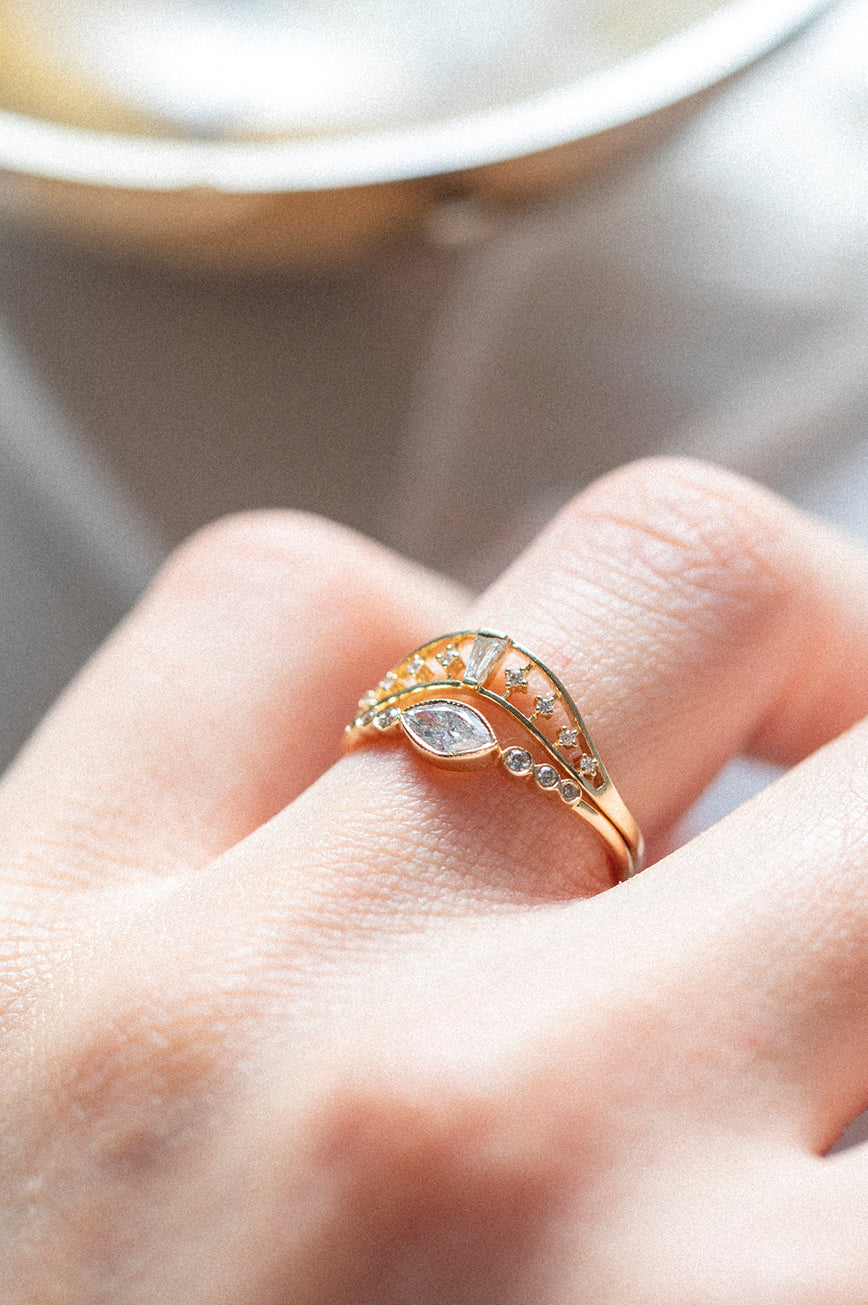 Crown ring in 14k light yellow gold set with a baguette diamond by Celine Daoust.