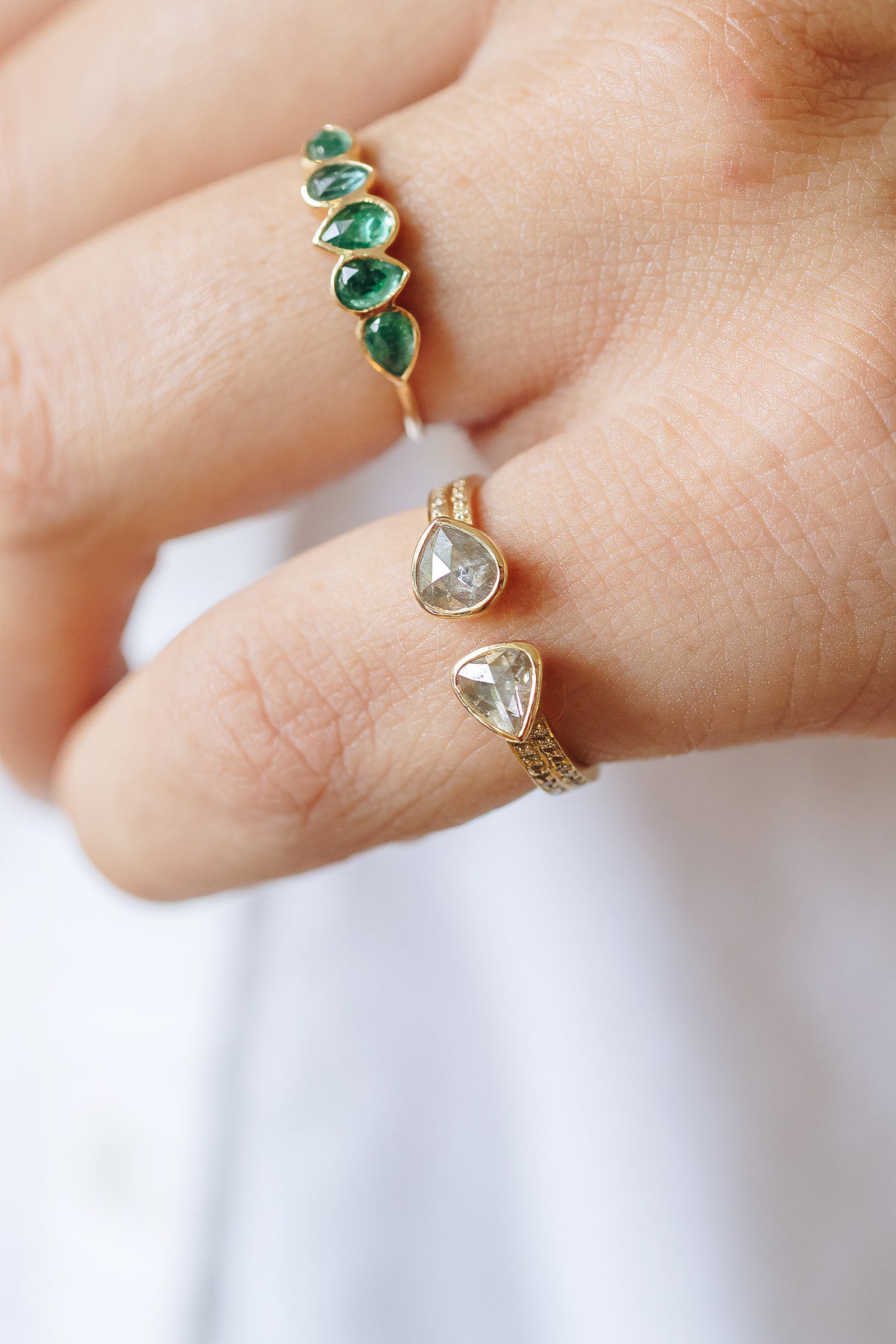 Close-up of the two champagne diamonds and diamond details on the open ring by Celine Daoust