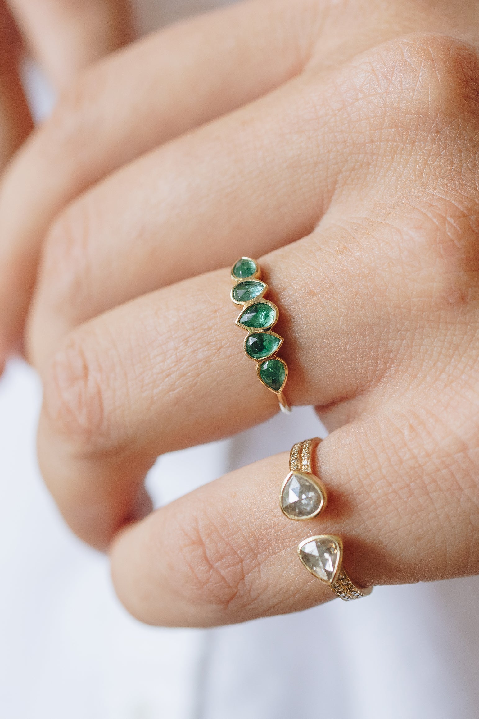 Multi emerald ring in 14k yellow gold with five pear-shaped emeralds by Celine Daoust."