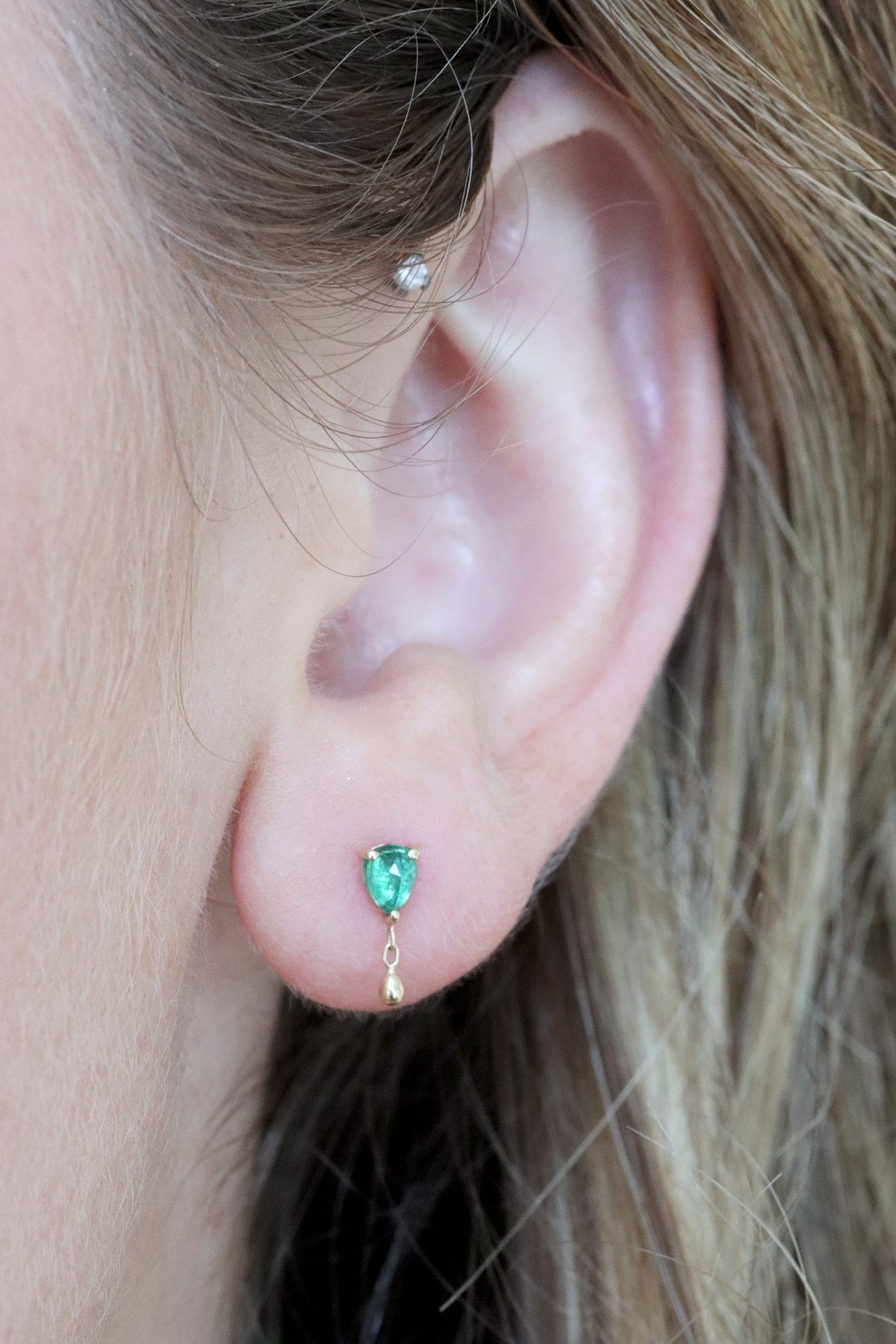 Emerald pear stud earring with dangling gold detail, threaded flatback, in 14k gold.