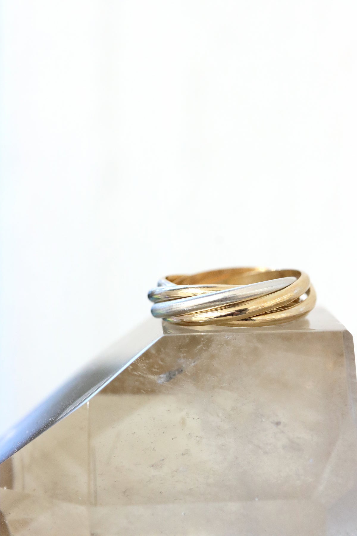 Gather mixed metal rolling ring with gold and silver bands in an interlocking design