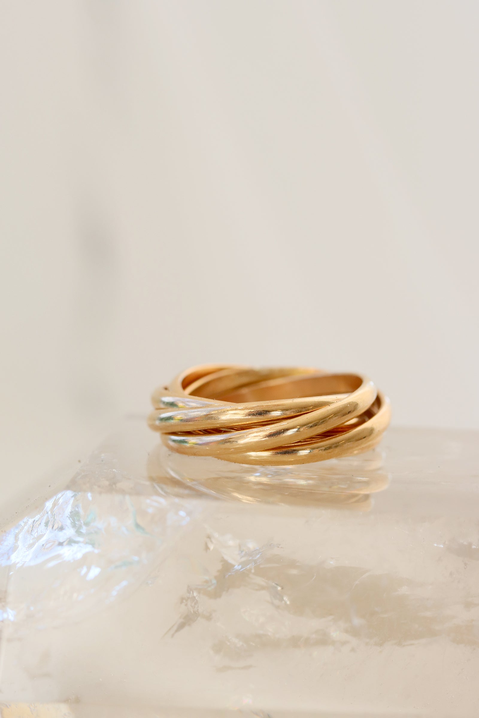 Gather rolling ring with five gold bands in an interlocking design