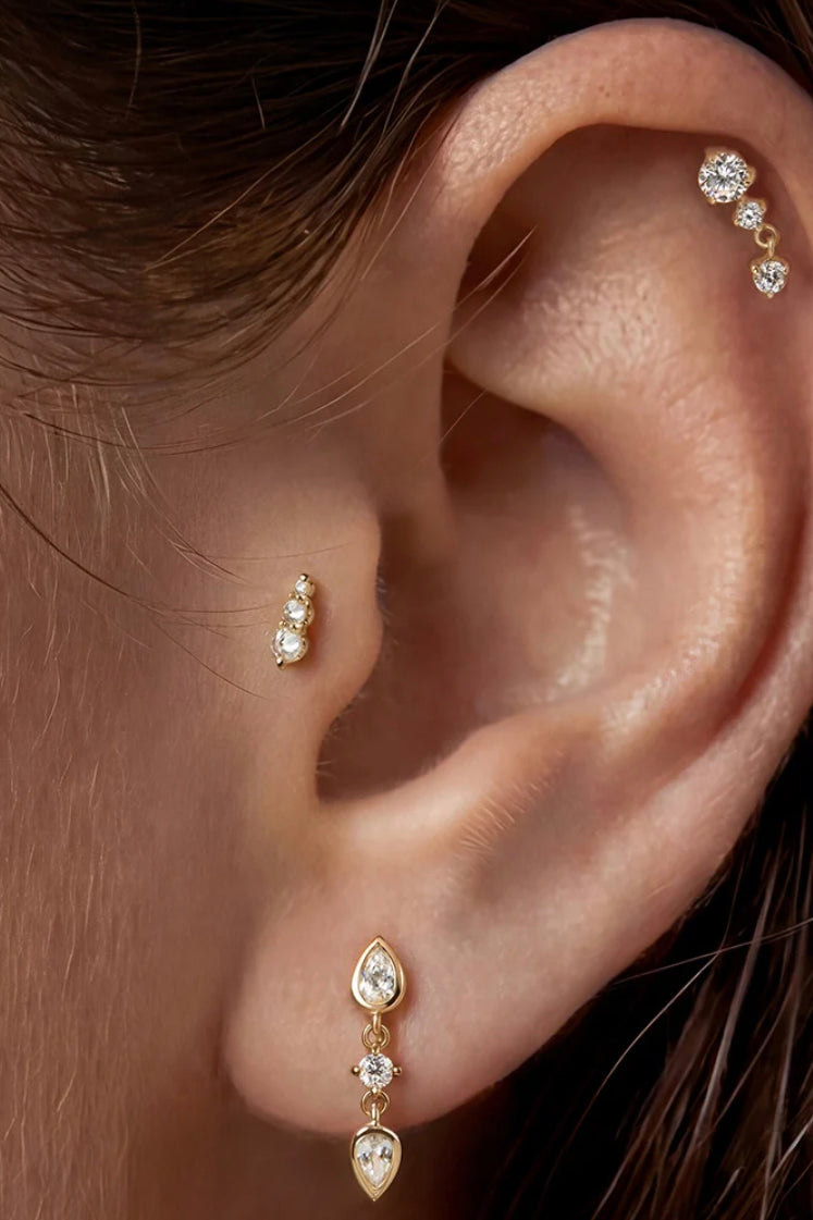 Three inverted round lab diamonds in a graduated curve on a 14K yellow gold threaded flat back stud