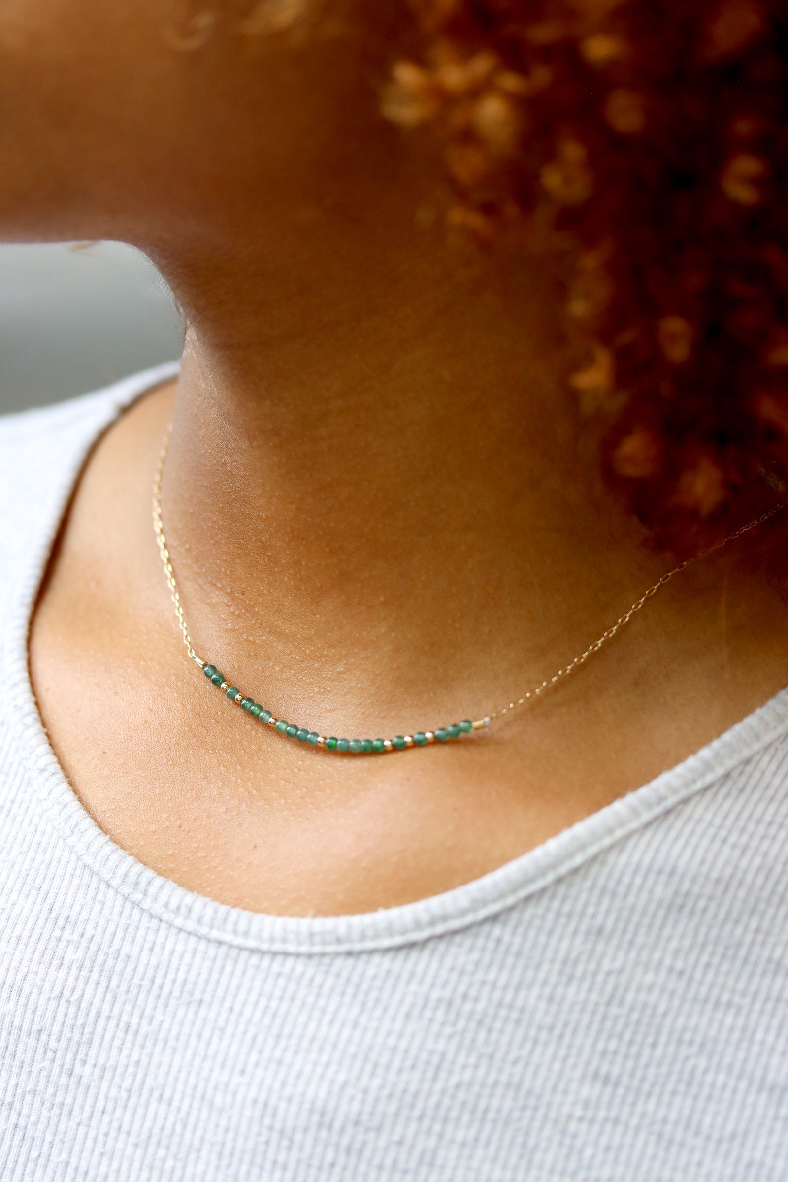 Jade Bar Necklace with Guatemalan jade beads centered on a fine gold chain, worn at the collarbone