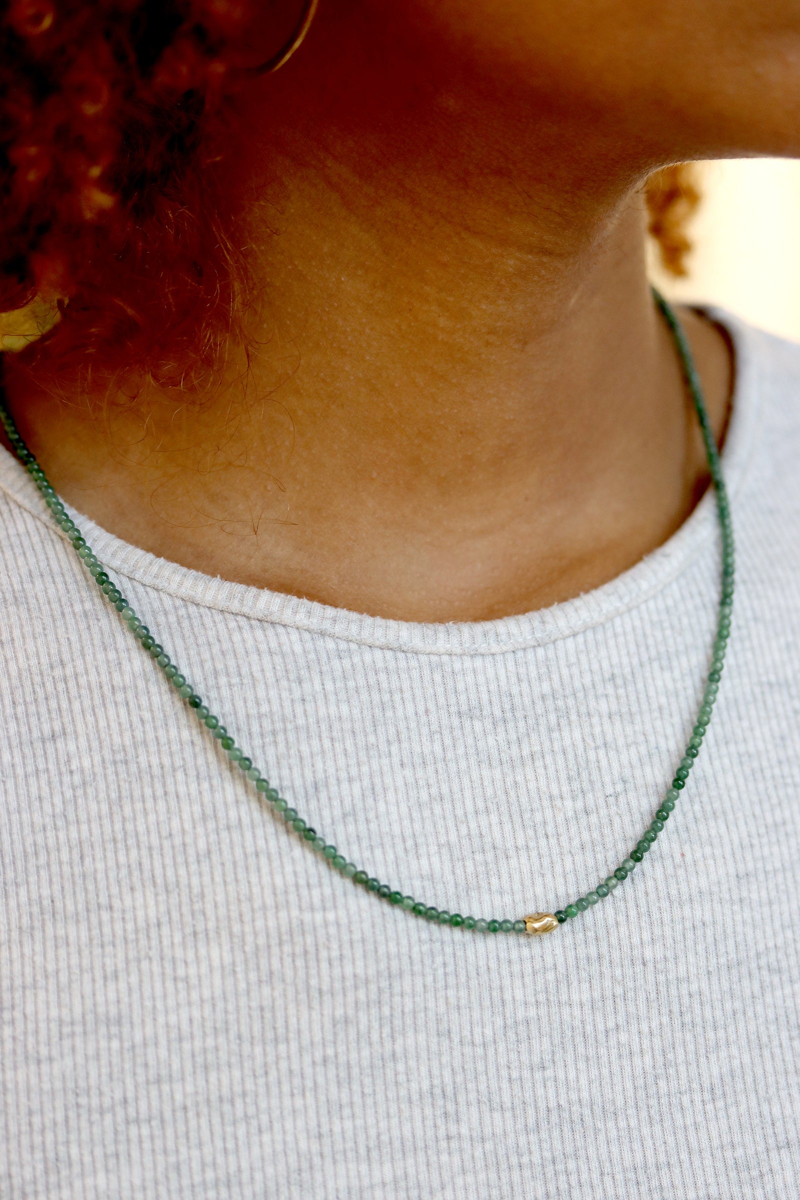 Jade Necklace or wrap bracelet with Guatemalan jade beads and a gold accent bead, white background