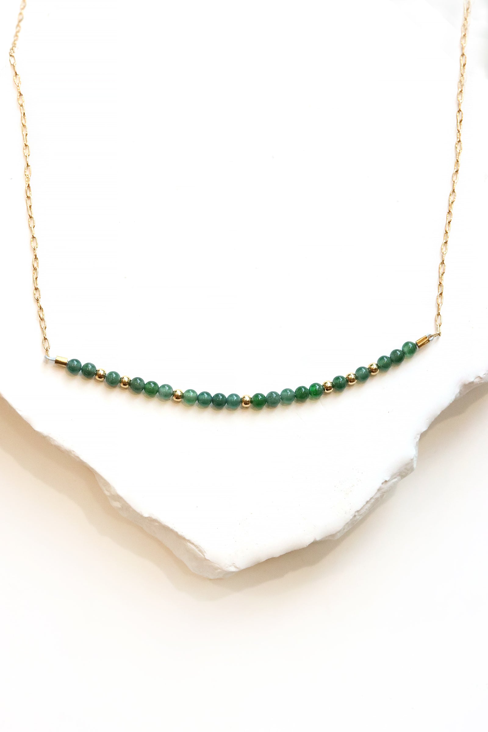 Jade Bar Necklace with Guatemalan jade beads centered on a fine gold chain, worn at the collarbone