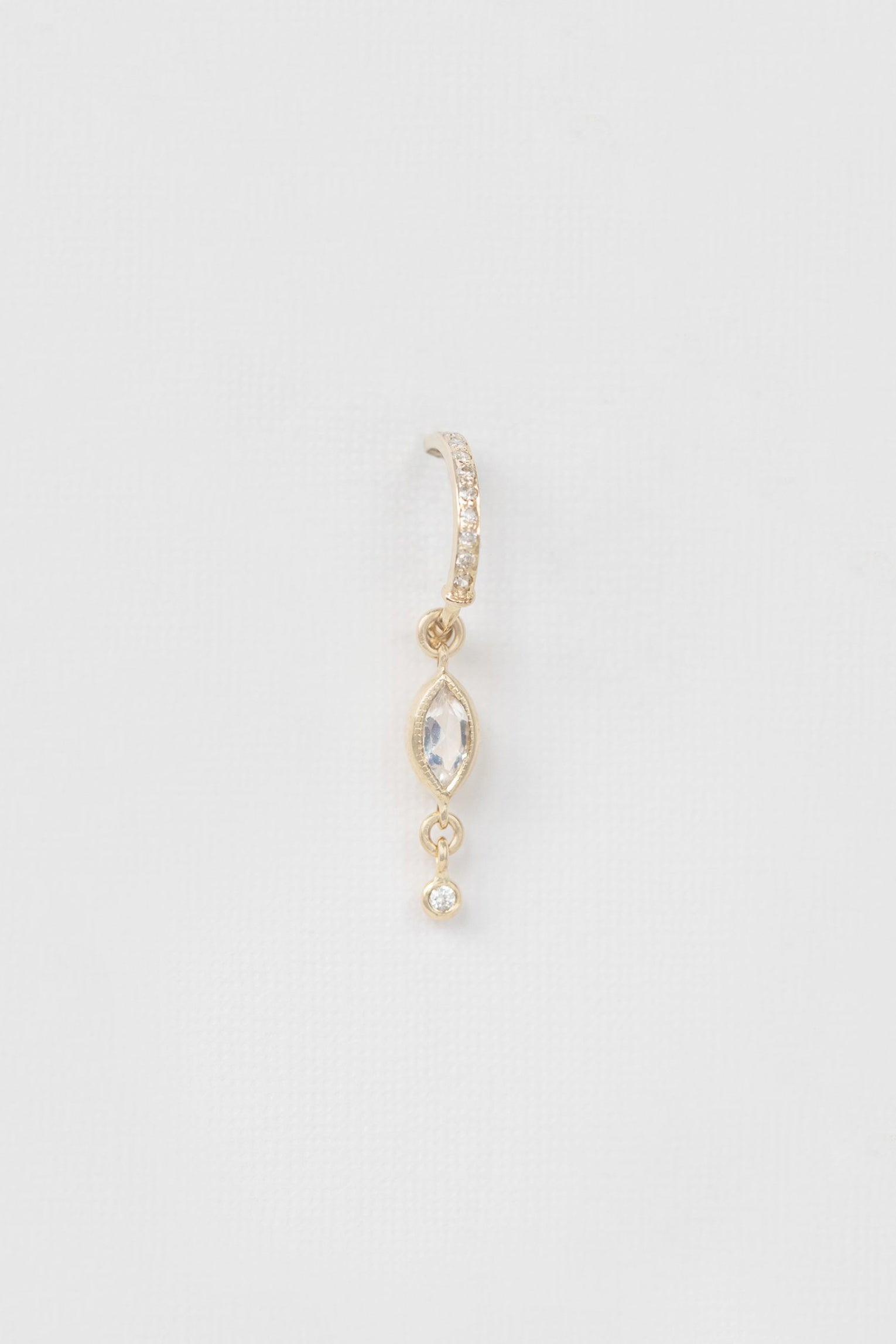 Marquise moonstone hoop earring in 14k light yellow gold with dangling diamonds by Celine Daoust.