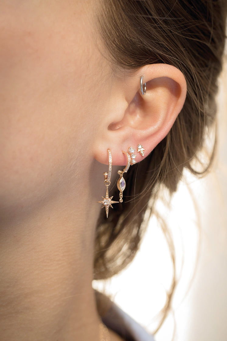 Marquise moonstone hoop earring in 14k light yellow gold with dangling diamonds by Celine Daoust.