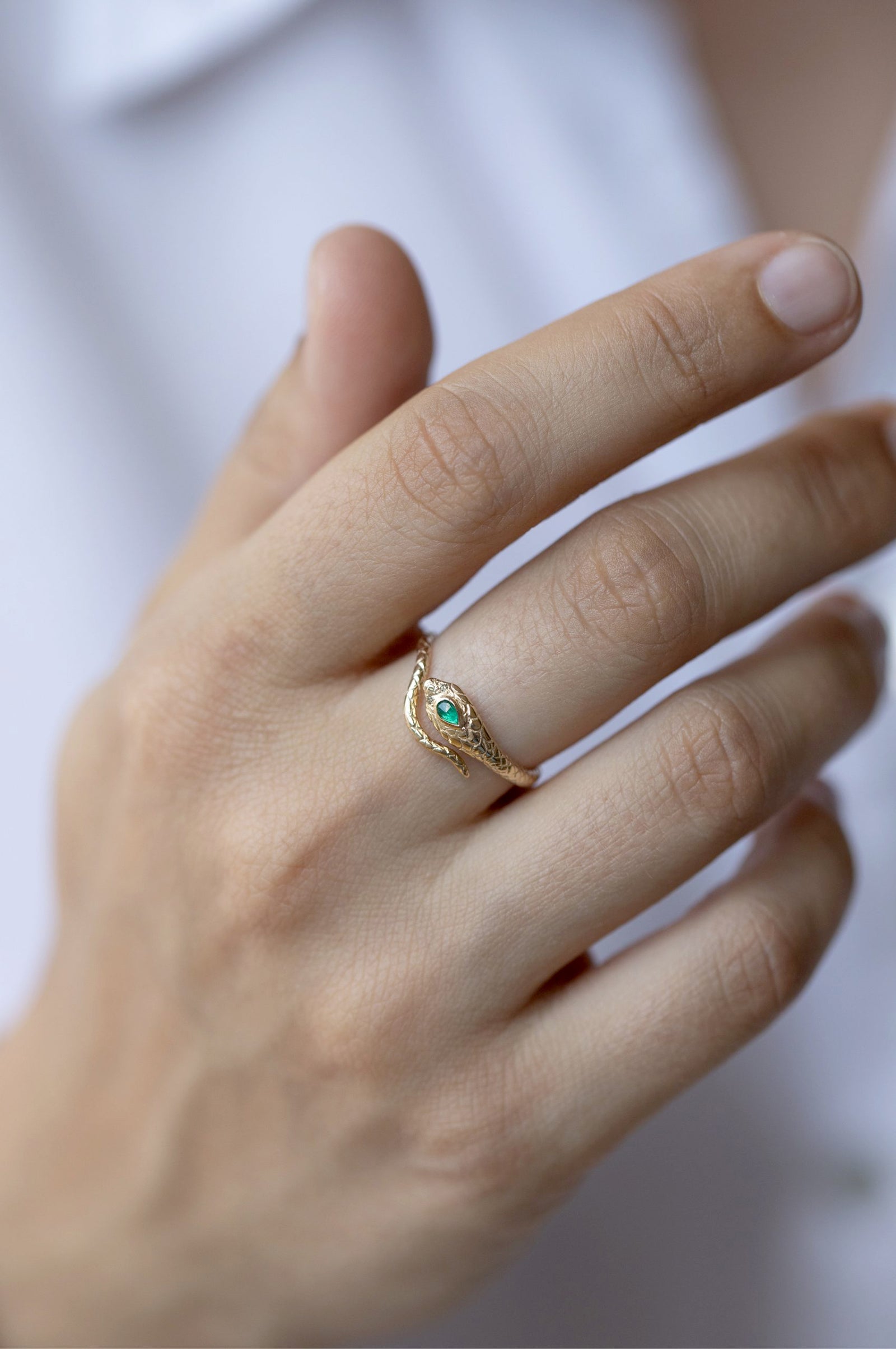 Cobra ring in 14k yellow gold set with an emerald and two diamonds by Celine Daoust.