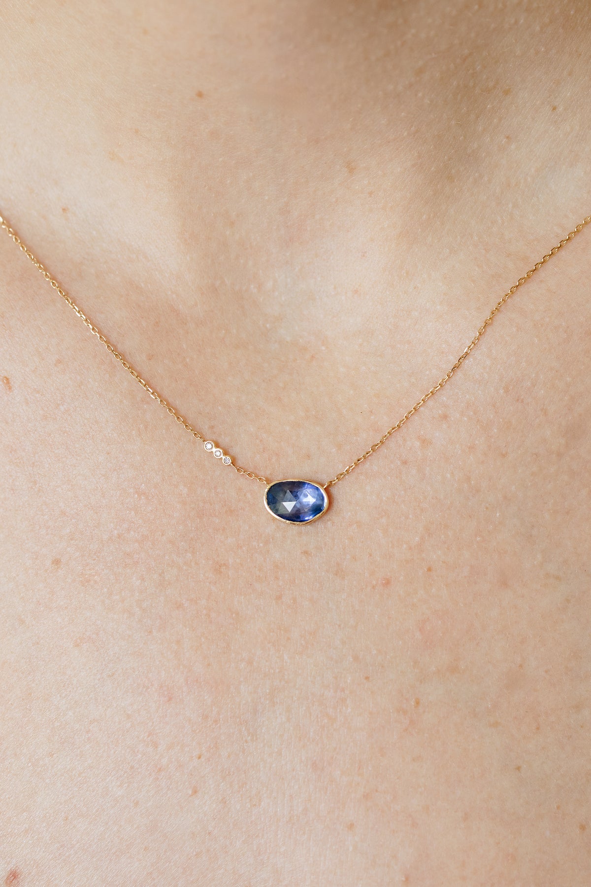 Tanzanite and three diamond pendant necklace in 14k yellow gold by Celine Daoust.