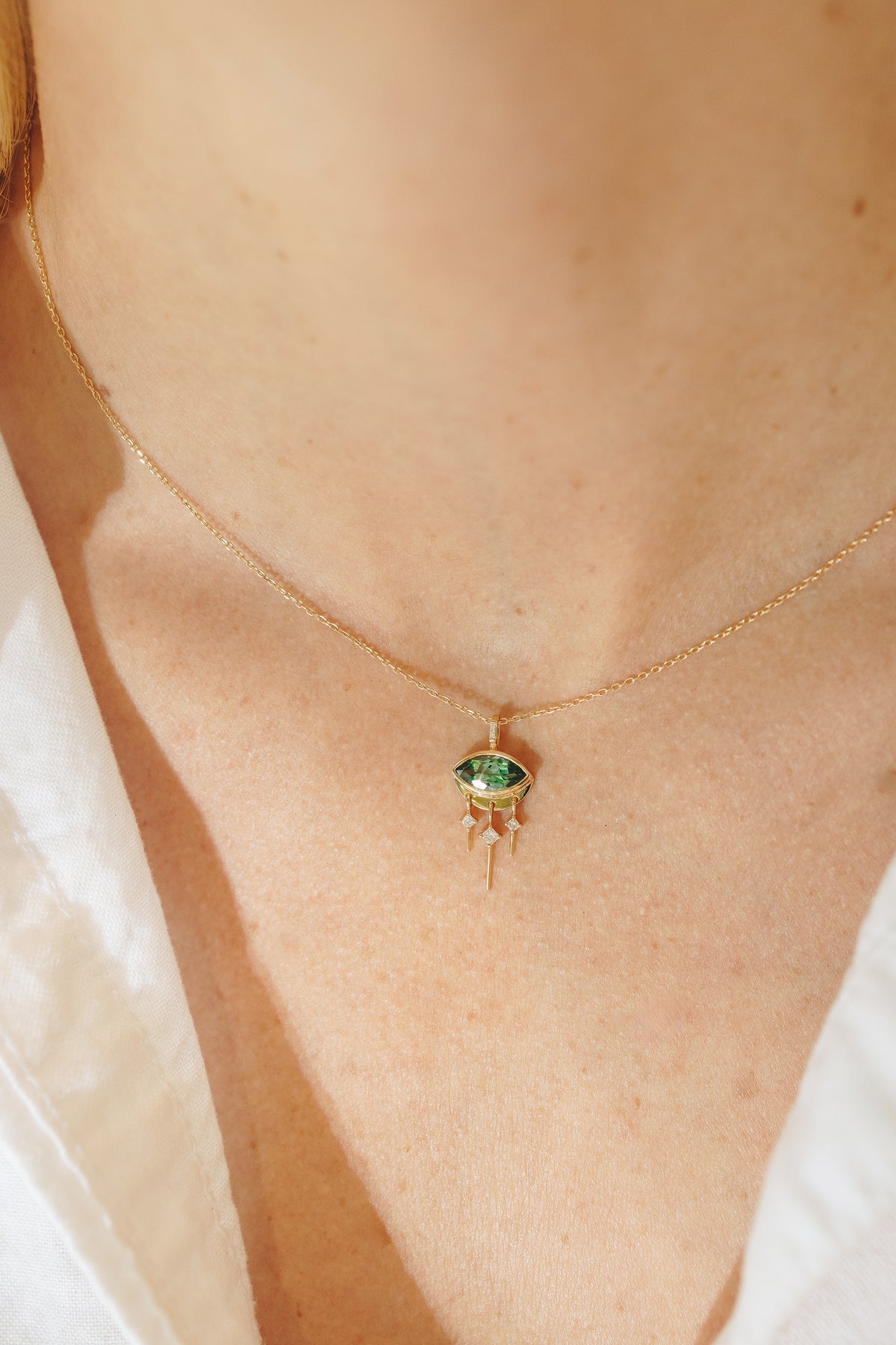 Another angle of the tourmaline marquise eye necklace showing the diamond chain detail
