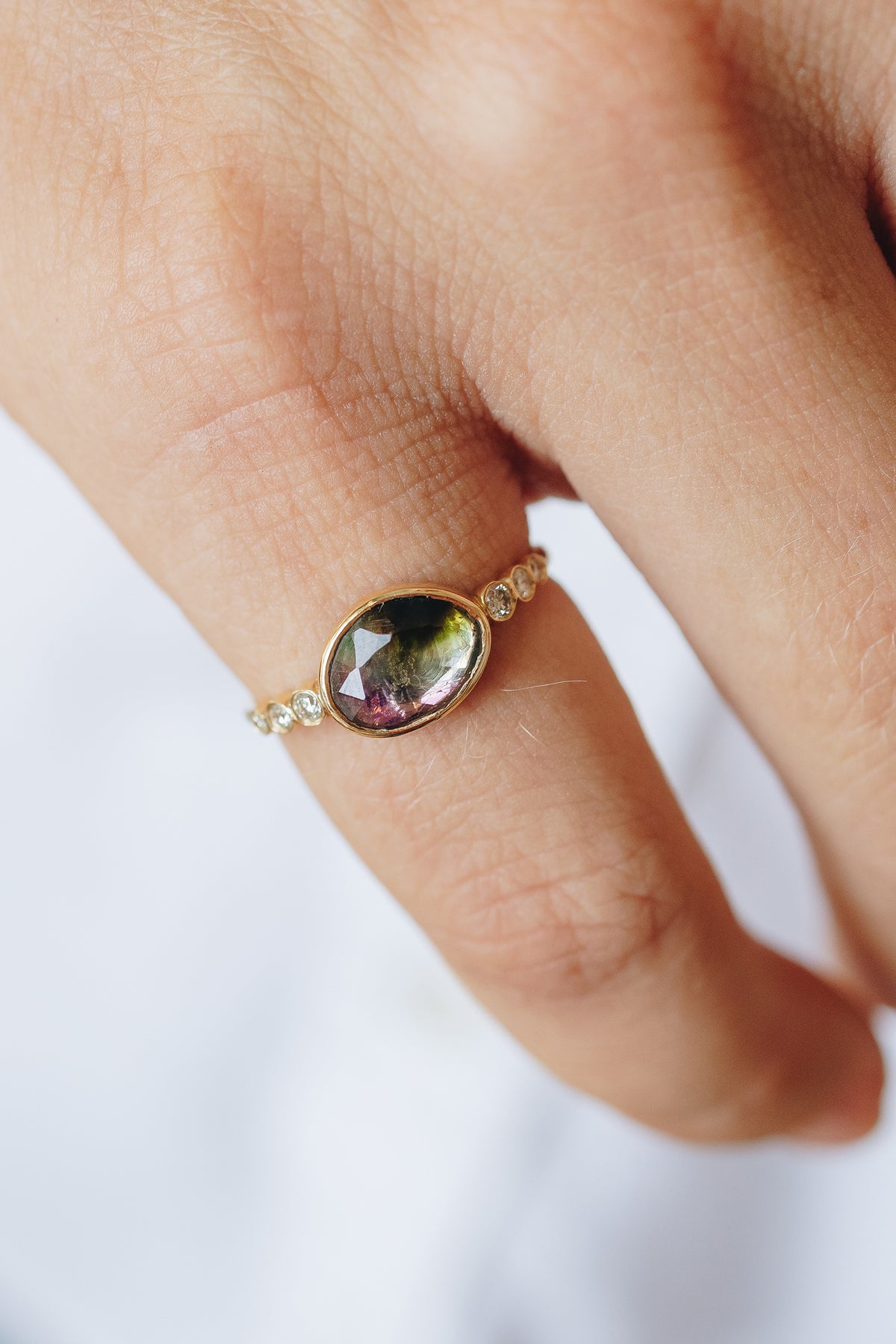Close-up of the rosecut watermelon tourmaline stone, showing its pink-to-green color gradient, set in the Celine Daoust ring