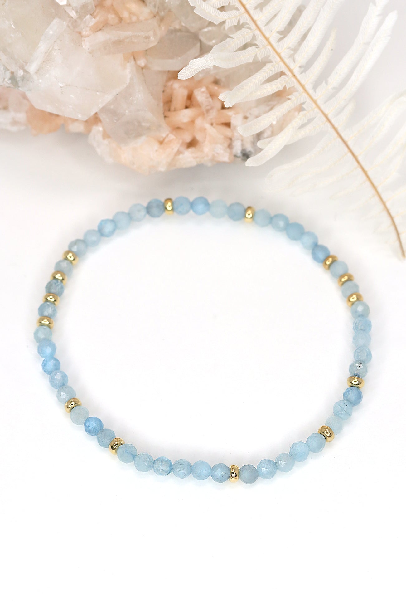 A stretch bracelet featuring faceted aquamarine beads and 14k gold filled accents
