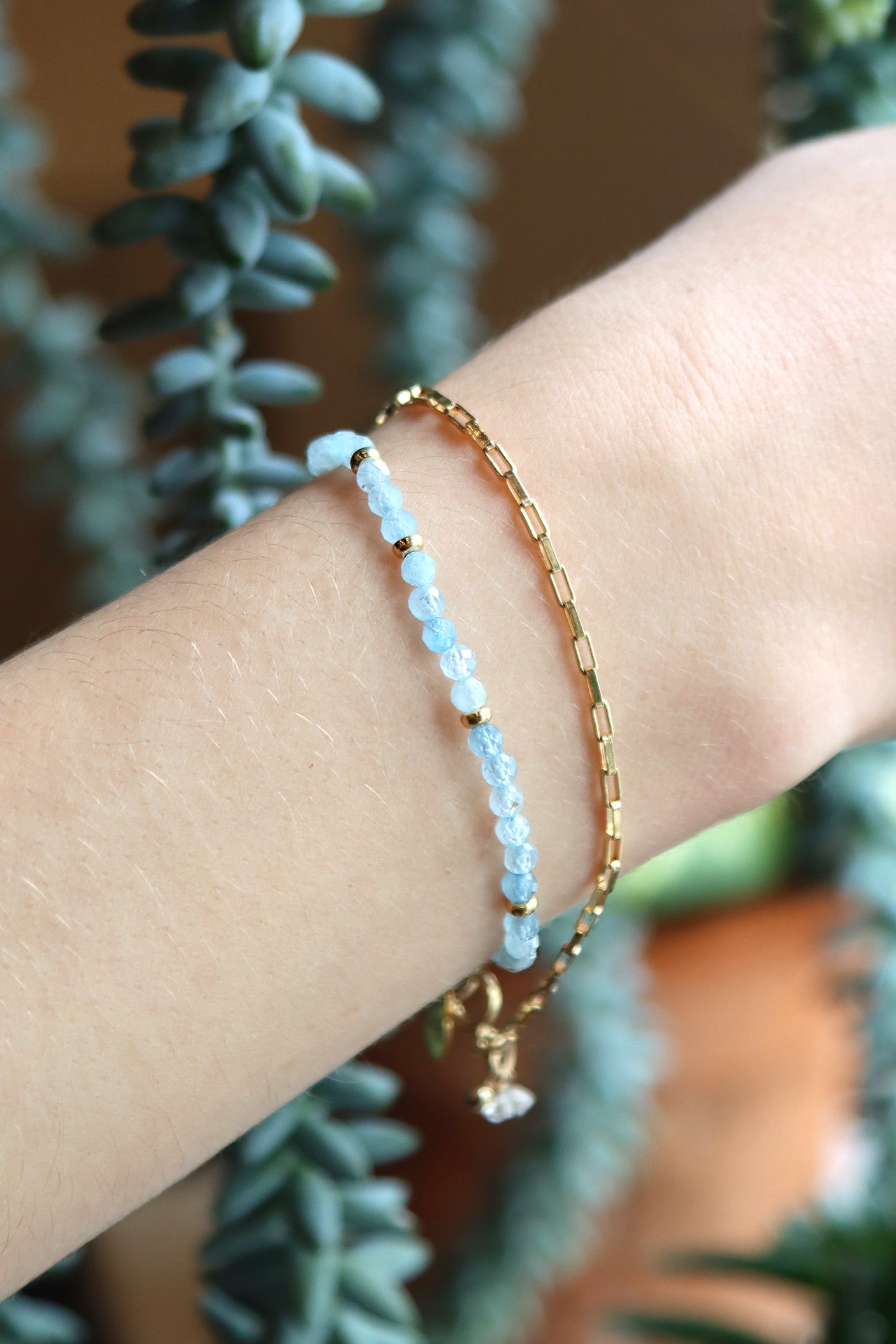 A stretch bracelet featuring faceted aquamarine beads and 14k gold filled accents
